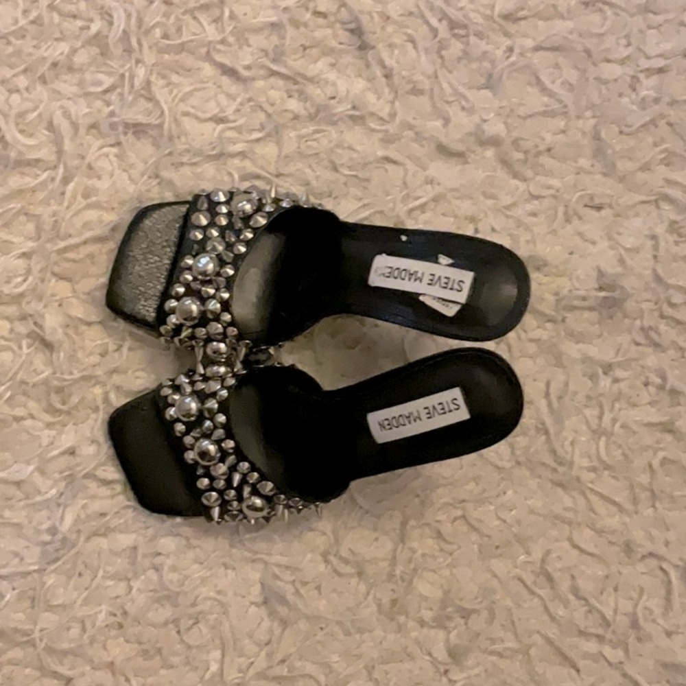 These Steve Madden open toe heels are black with silver spikes